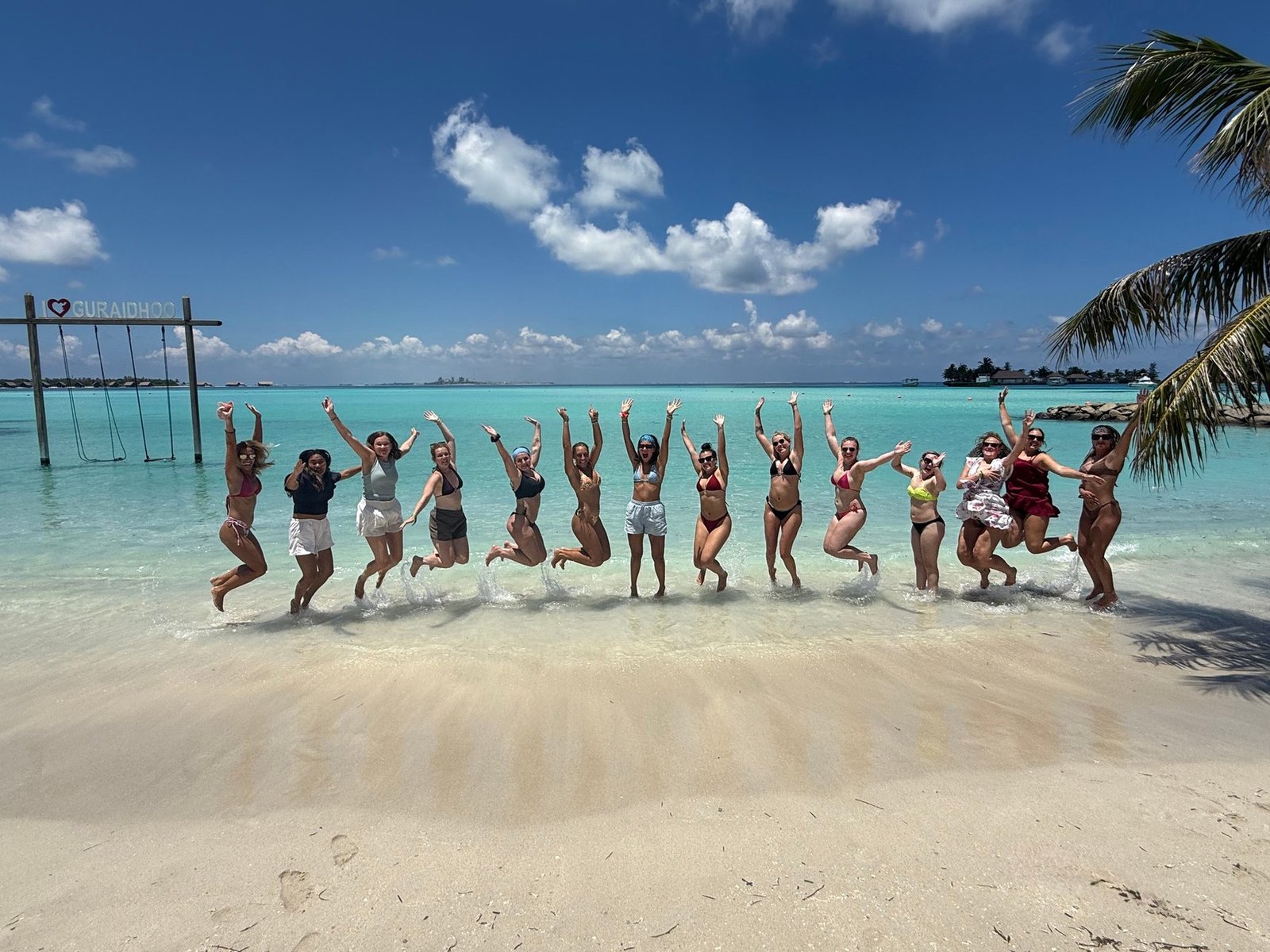 The whole group jumping on the beach in Guraidhoo