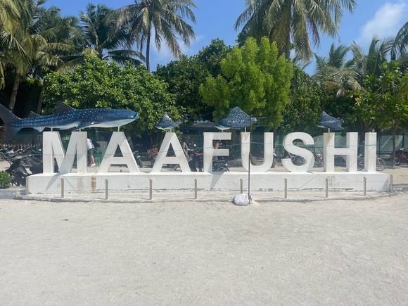 The Maafushi island sign standing on the beach