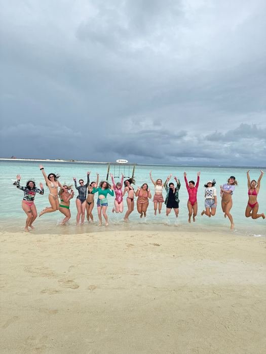 The whole group jumping together on a sandbank